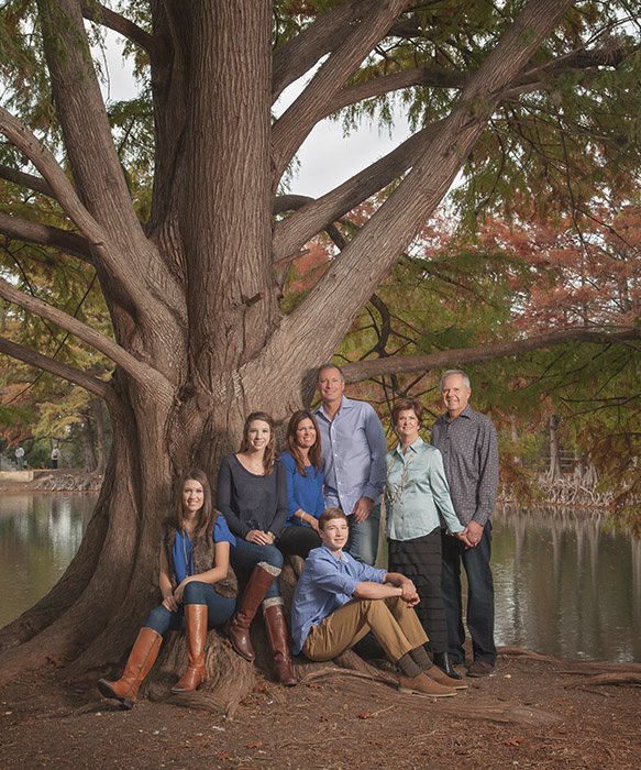 Fine art studio portrait of a family with classical posing and painterly lighting by Hayward Gaude